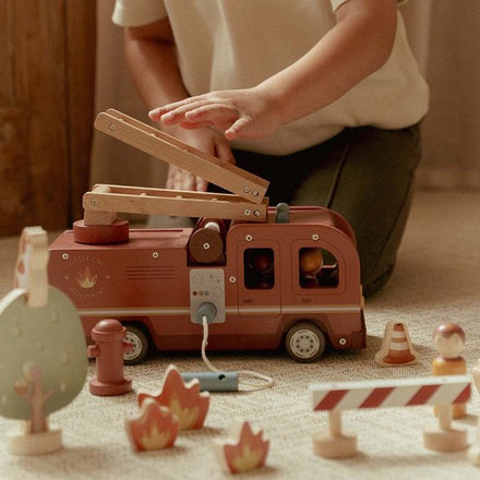 Little Dutch houten brandweerwagen set met popjes, kind speelt op de vloer
