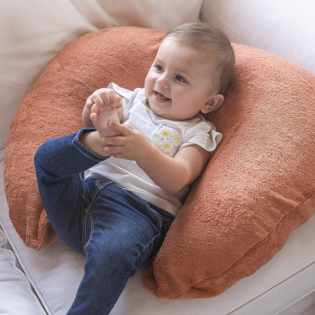 Baby zit tegen het Timboo borstvoedingskussen in Sunrise Orange